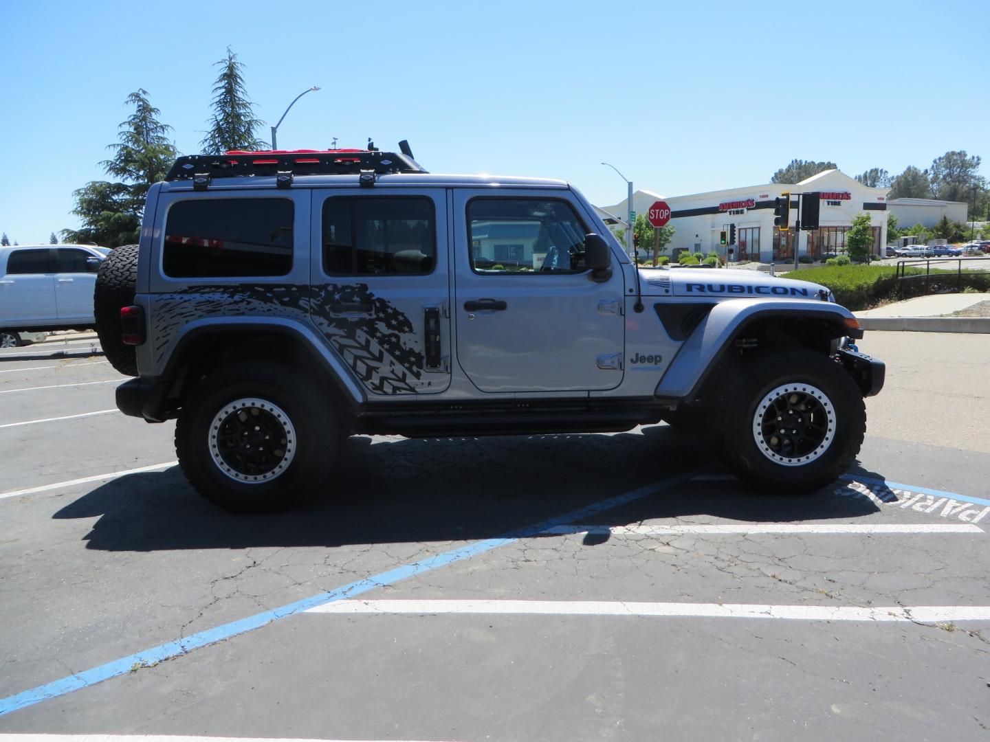 2021 SILVER /BLACK Jeep Wrangler Unlimited Rubicon 4XE 4d SUV 4wd (1C4JJXR63MW) with an 2.0L L4 DOHC 16V TURBO engine, automatic transmission, located at 2630 Grass Valley Highway, Auburn, CA, 95603, (530) 508-5100, 38.937893, -121.095482 - Impressive 4xe Rubicon with a ton of extras that include Fox 3.0 internal bypass front and rear shocks, 315 BFG KO2 tires, Warn winch, Factor 55 Ultra hook, Front bumper stinger, Rigid Pods on front bumper, Rigid A series lights in the roof rack, DV8 lockable hood pins, Westin Running boards, Fury d - Photo#3